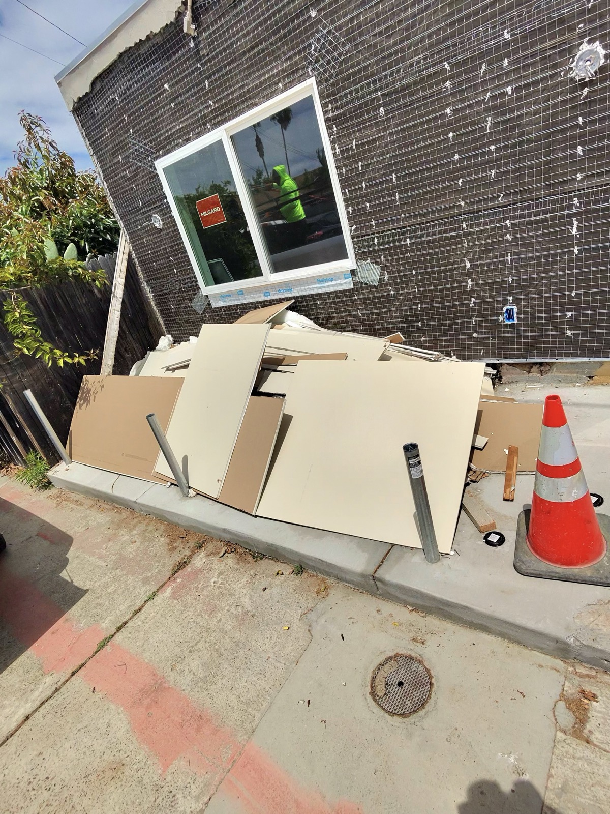 Before — pile of junk and debris in San Diego property